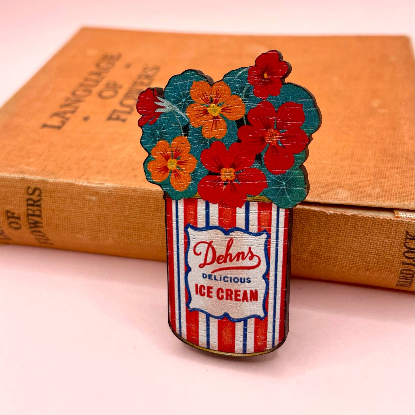 Pin with ice cream can and flowers design on a pink background