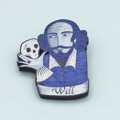 A wooden pin badge featuring William Shakespeare holding a skull